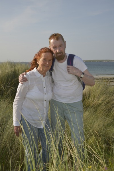 Mary Attenborough and Michael Gallagher overlooking the sea at Machaire Rabhartaigh, Gort a' Choirce, County Donegal, Ireland, July 2025 - photo Alan Lavender